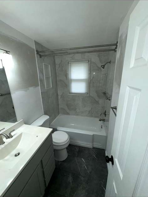 Bathroom remodel with marble tile tub-shower surround and new vanity